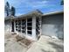 Charming exterior of the home featuring a unique window enclosure and freshly painted siding at 6710 Hibiscus S Ave, South Pasadena, FL 33707