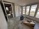 Enclosed porch ready for finishing touches, offering natural light and views to the backyard at 6710 Hibiscus S Ave, South Pasadena, FL 33707