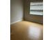 Bright bedroom featuring neutral walls, natural light and wood laminate flooring at 7210 N Manhattan Ave # 1311, Tampa, FL 33614