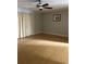 Bright living room featuring hardwood floors, ceiling fan and light-filled windows at 7210 N Manhattan Ave # 1311, Tampa, FL 33614