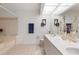 Bright bathroom with double vanity, soaking tub, and large mirror at 745 Pinellas Bayway S # 206, St Petersburg, FL 33715