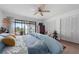 Bright bedroom with a king bed, sliding glass doors, and a ceiling fan at 745 Pinellas Bayway S # 206, St Petersburg, FL 33715