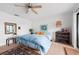 Bedroom with a king size bed, ceiling fan, and sliding glass doors with a balcony view at 745 Pinellas Bayway S # 206, St Petersburg, FL 33715