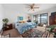 Bright bedroom featuring a ceiling fan, sliding glass doors, and a comfortable king bed at 745 Pinellas Bayway S # 206, St Petersburg, FL 33715
