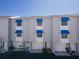 Exterior of three story townhomes with blue awnings and garage parking at 745 Pinellas Bayway S # 206, St Petersburg, FL 33715