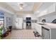 Bright kitchen featuring white cabinets, stainless steel appliances, and a ceiling fan at 745 Pinellas Bayway S # 206, St Petersburg, FL 33715