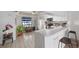 Bright, airy kitchen with white countertops, tiled backsplash and bar seating at 745 Pinellas Bayway S # 206, St Petersburg, FL 33715