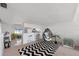 Open-concept living area with bar seating and hanging chair near kitchen at 745 Pinellas Bayway S # 206, St Petersburg, FL 33715