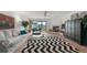 Bright and spacious living room with a fireplace and sliding glass doors to balcony at 745 Pinellas Bayway S # 206, St Petersburg, FL 33715
