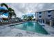 Community pool with palm trees and boat docks in the background on a sunny day at 745 Pinellas Bayway S # 206, St Petersburg, FL 33715