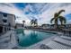 Community pool with lounge chairs, palm trees and easy access to marina with boat slips at 745 Pinellas Bayway S # 206, St Petersburg, FL 33715