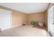 Empty room with tile floors, tan walls, white trim, and a door to the outside at 745 Pinellas Bayway S # 206, St Petersburg, FL 33715