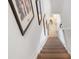Carpeted stairs leading downstairs, with art hanging on the white walls at 745 Pinellas Bayway S # 206, St Petersburg, FL 33715
