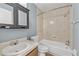 Well-lit bathroom featuring a shower and tub combination with a classic vanity and medicine cabinet at 7627 Deleon Ct, Tampa, FL 33615