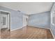 Spacious bedroom with sleek wood floors, closet, and bright windows dressed with neutral curtains at 7627 Deleon Ct, Tampa, FL 33615