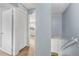 Upstairs hallway featuring neutral paint, laminate flooring, and access to the bedrooms at 7627 Deleon Ct, Tampa, FL 33615