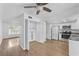 Open kitchen features stainless steel appliances and leads to the dining area with laminate flooring at 7627 Deleon Ct, Tampa, FL 33615