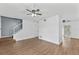 Spacious living room with laminate flooring and a ceiling fan for comfortable living at 7627 Deleon Ct, Tampa, FL 33615