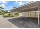 Designated parking area under a canopy, complemented by lush landscaping at 7627 Deleon Ct, Tampa, FL 33615