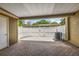 Covered patio featuring brick flooring and a white fence surrounding the outdoor space at 7627 Deleon Ct, Tampa, FL 33615