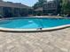 Community pool area with lounge chairs and well-maintained landscaping, perfect for relaxation at 7627 Deleon Ct, Tampa, FL 33615