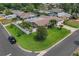 Aerial view of a home with a well-manicured lawn, fence, palm trees and a driveway at 7851 120Th St, Seminole, FL 33772