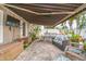 Back patio featuring pavers, outdoor seating, a ceiling fan, and a retractable awning at 7851 120Th St, Seminole, FL 33772