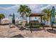 Relaxing backyard patio with a swing set, lounge chairs, grill, and beautiful landscaping at 7851 120Th St, Seminole, FL 33772