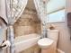 Well-lit bathroom featuring a tub with shower, patterned shower curtain, and tiled walls at 7851 120Th St, Seminole, FL 33772