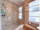 Walk-in shower featuring glass door, decorative tile, and modern fixtures at 7851 120Th St, Seminole, FL 33772