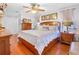 Cozy bedroom featuring wood floors, a ceiling fan, and warm lighting at 7851 120Th St, Seminole, FL 33772