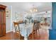Dining room with chandelier and view of the lanai through sliding glass doors at 7851 120Th St, Seminole, FL 33772