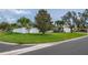 Single-story home with a well-manicured lawn, privacy fence, and palm trees on a corner lot at 7851 120Th St, Seminole, FL 33772