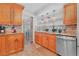 Well-lit kitchen features wood cabinets, granite countertops, and stainless steel appliances at 7851 120Th St, Seminole, FL 33772