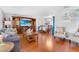 Open living area with a large screen TV and wood floors flowing to the dining area at 7851 120Th St, Seminole, FL 33772