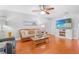 Bright living room with hardwood floors, comfortable seating, and a wall-mounted TV at 7851 120Th St, Seminole, FL 33772
