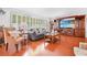Cozy living room with shuttered windows, wood floors and entertainment center at 7851 120Th St, Seminole, FL 33772