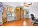 Office area with wood floors, storage options, and ample lighting at 7851 120Th St, Seminole, FL 33772