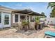 Inviting patio with an awning, wicker chairs, potted plants, and an outdoor seating area for relaxing and entertaining at 7851 120Th St, Seminole, FL 33772