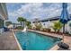 Refreshing in-ground pool surrounded by lush landscaping, ideal for summer fun and relaxation at 7851 120Th St, Seminole, FL 33772