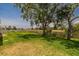 Spacious back yard featuring mature trees and a serene golf course view at 817 Eagle Ln, Apollo Beach, FL 33572