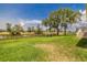 Spacious backyard featuring a tranquil pond and ample green space at 817 Eagle Ln, Apollo Beach, FL 33572