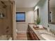 Bathroom featuring dual sinks, granite countertops, and a shower with a curtain at 817 Eagle Ln, Apollo Beach, FL 33572