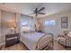 Bedroom featuring wood look tile flooring, a ceiling fan, and bright windows at 817 Eagle Ln, Apollo Beach, FL 33572