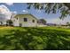 Exterior of home with well-maintained lawn, screened-in lanai and canal views at 817 Eagle Ln, Apollo Beach, FL 33572