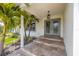 Elegant front entryway with decorative glass doors and charming landscaping at 817 Eagle Ln, Apollo Beach, FL 33572