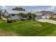Well-maintained home with lush lawn, palm trees, and a charming front facade at 817 Eagle Ln, Apollo Beach, FL 33572