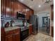Well-appointed kitchen featuring stainless steel appliances, dark cabinetry, and granite countertops at 817 Eagle Ln, Apollo Beach, FL 33572