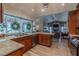 Open concept kitchen with granite countertops, dark cabinetry, stainless steel appliances, open to the living room at 817 Eagle Ln, Apollo Beach, FL 33572