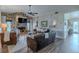 Inviting living room with a stone fireplace, wood-look floors, stylish furnishings, and natural light at 817 Eagle Ln, Apollo Beach, FL 33572